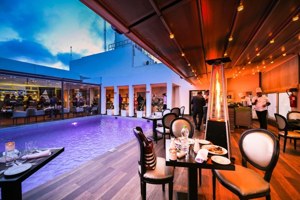 Elegant rooftop restaurant with poolside dining at sunset. Perfect for a luxurious dining experience.
